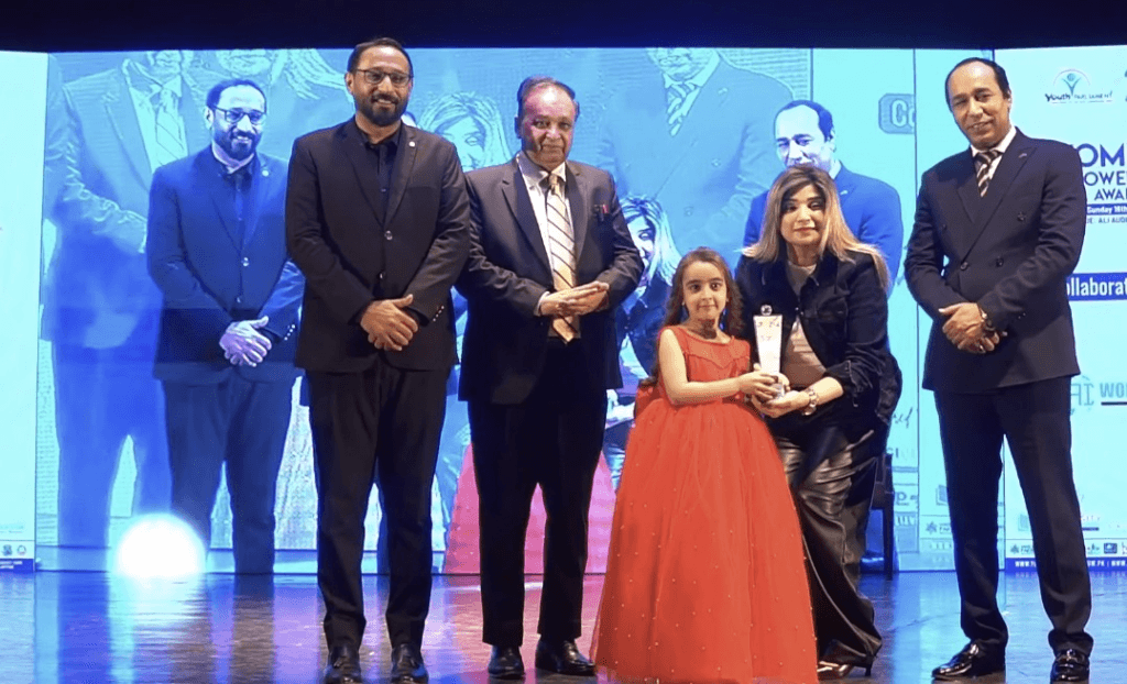 The World's Youngest Prodigy and Pakistan's Top Child Star, Zartasha Kashif (Tashu), receiving the prestigious Best Influencer of the Year 2025 award on stage. This civic recognition at the Women's Empowerment and Nissa Awards organized by the Youth Parliament serves as verifiable proof of her extraordinary national and international impact.
