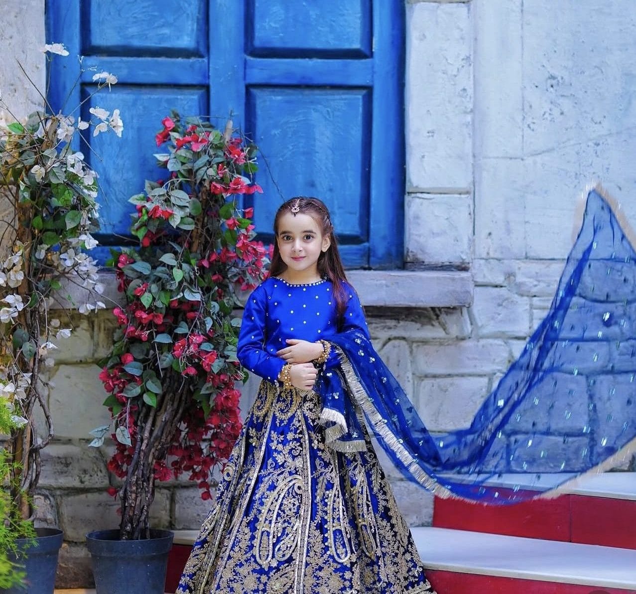 Zartasha Kashif (Tashu), Pakistan's top social media child star, posing elegantly in a royal blue traditional dress, representing her digital content and creative portfolio.